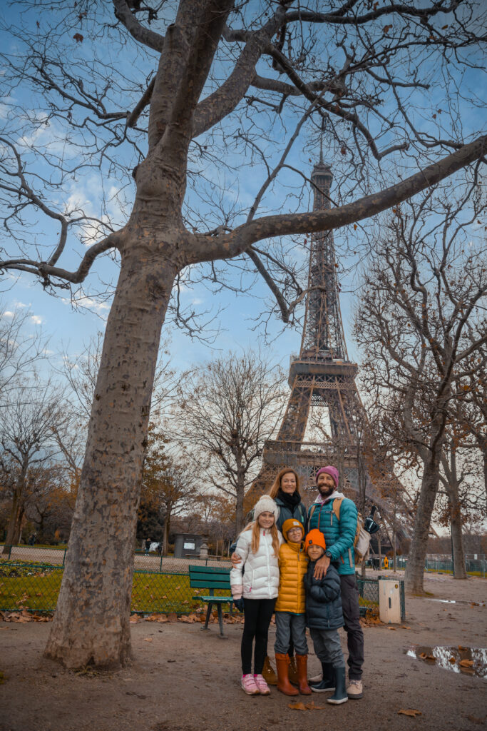 Family standing in front of the Eiffel Tower