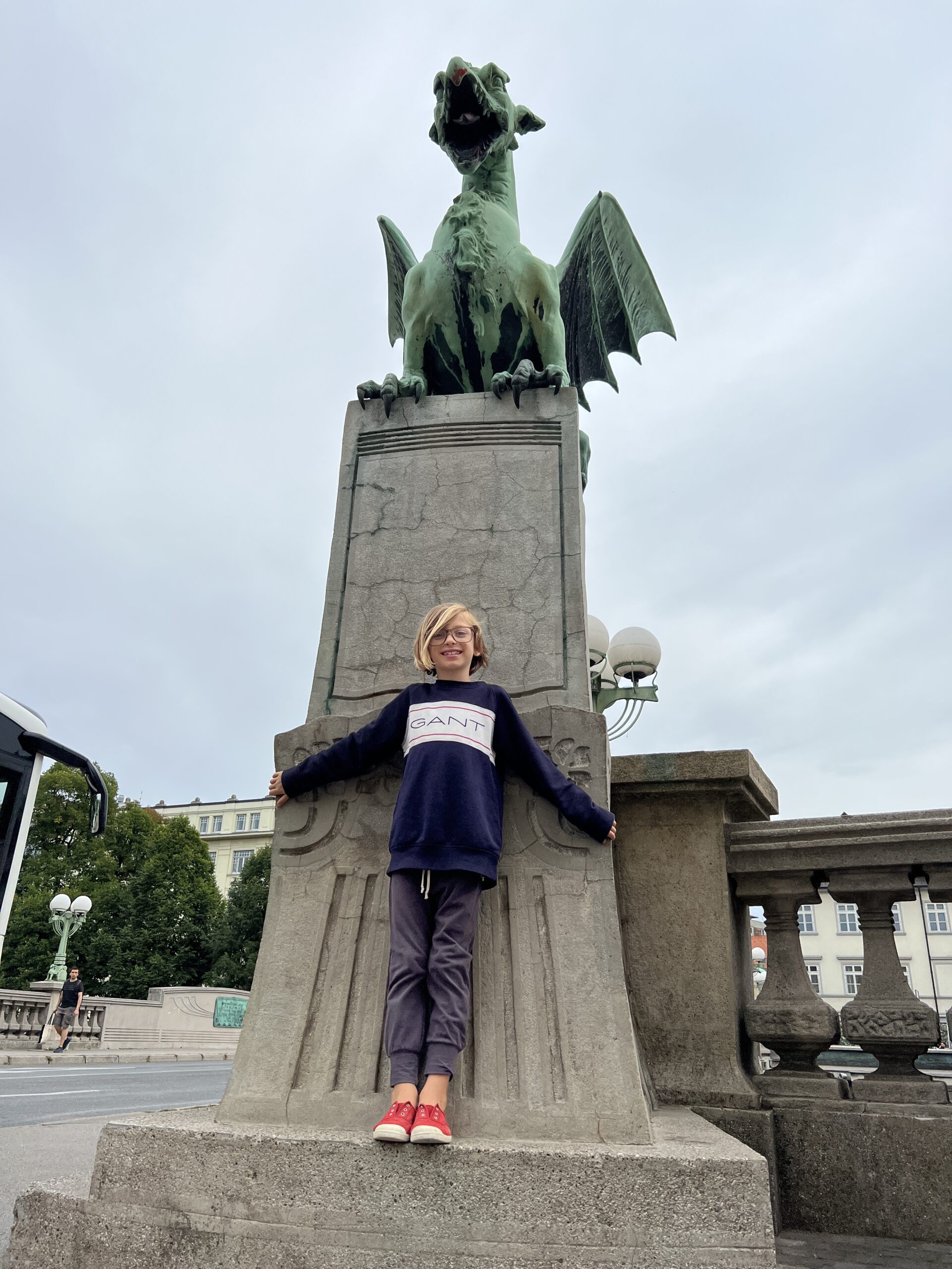 a woman standing next to a statue