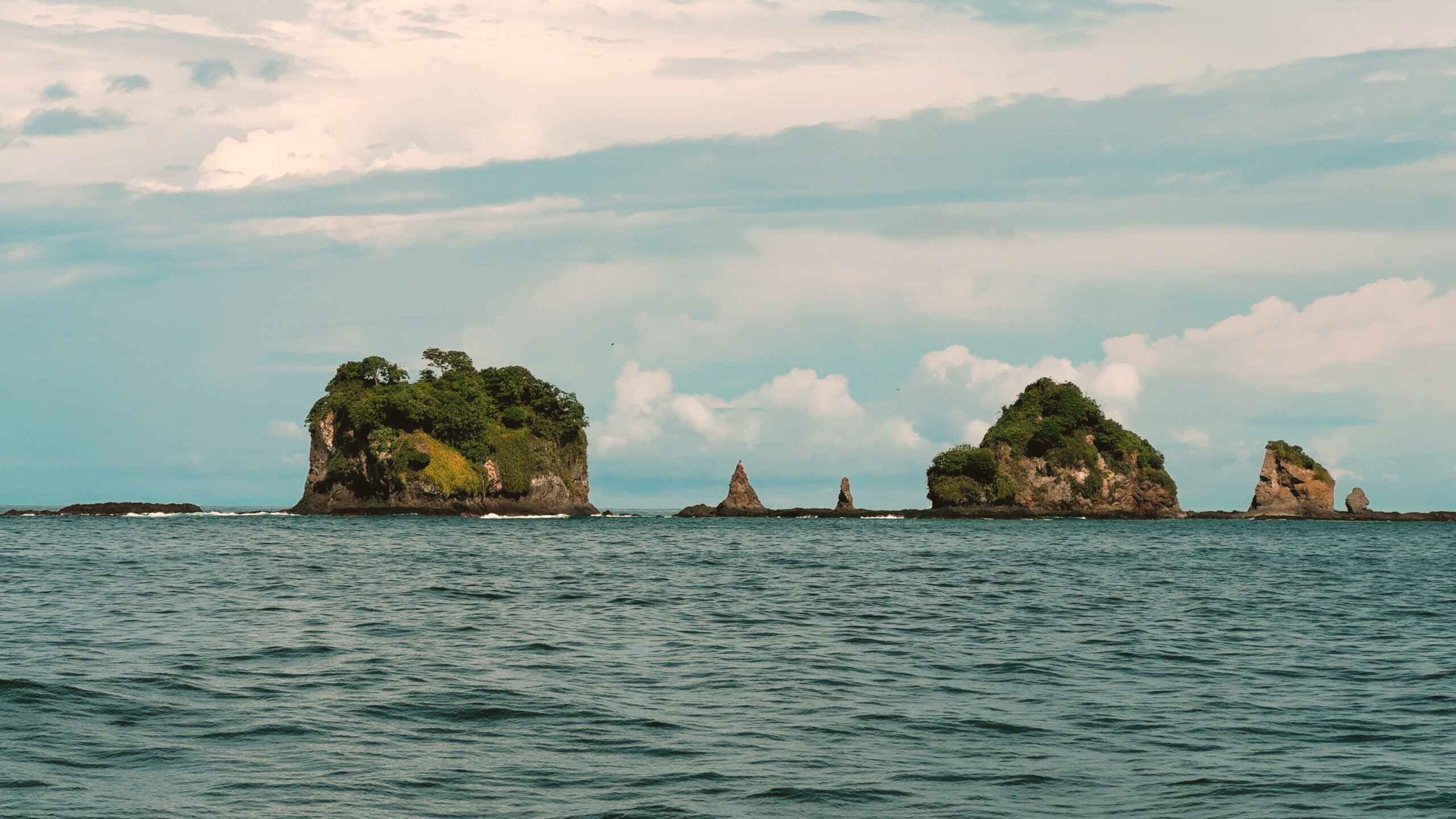 Small rocky islands in ocean.