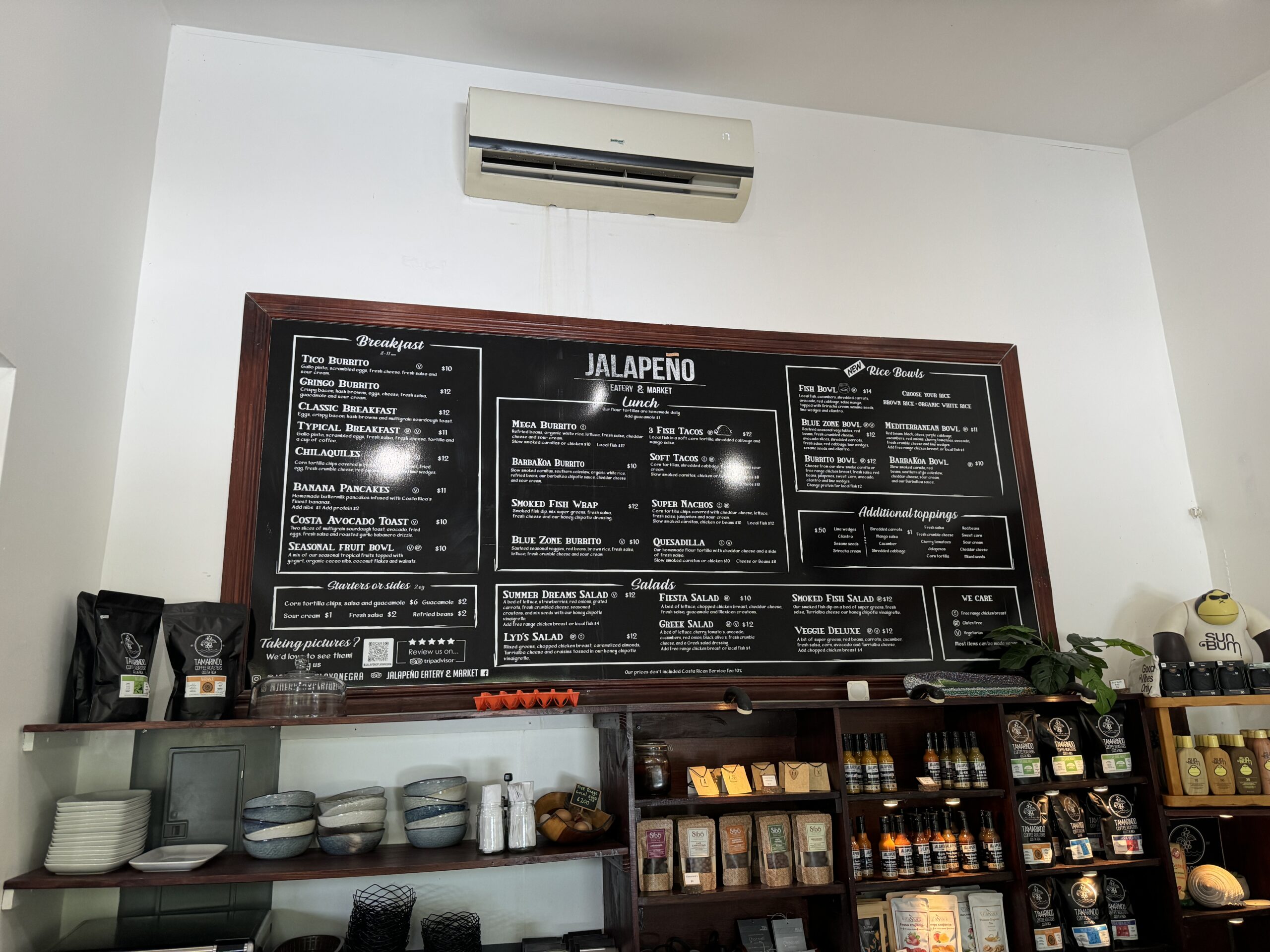 Cafe menu on blackboard wall.