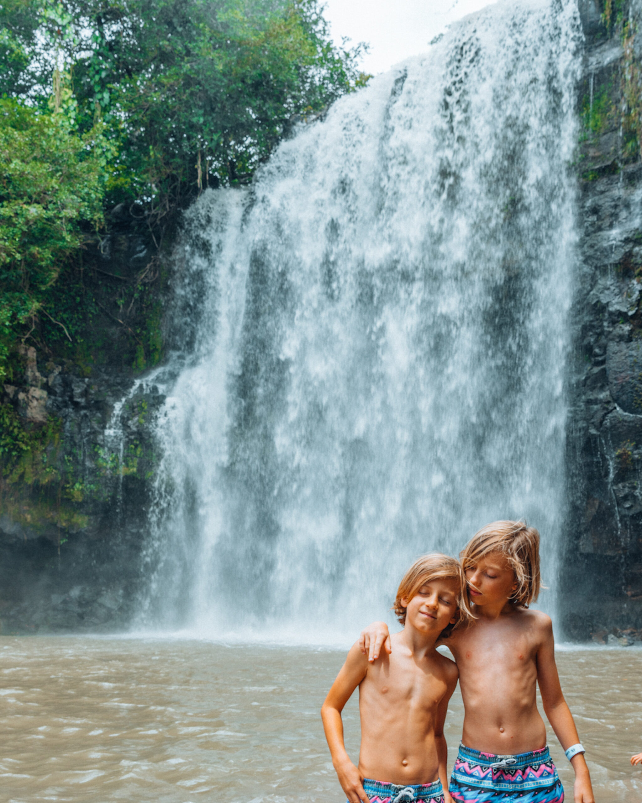 Two children by waterfall.