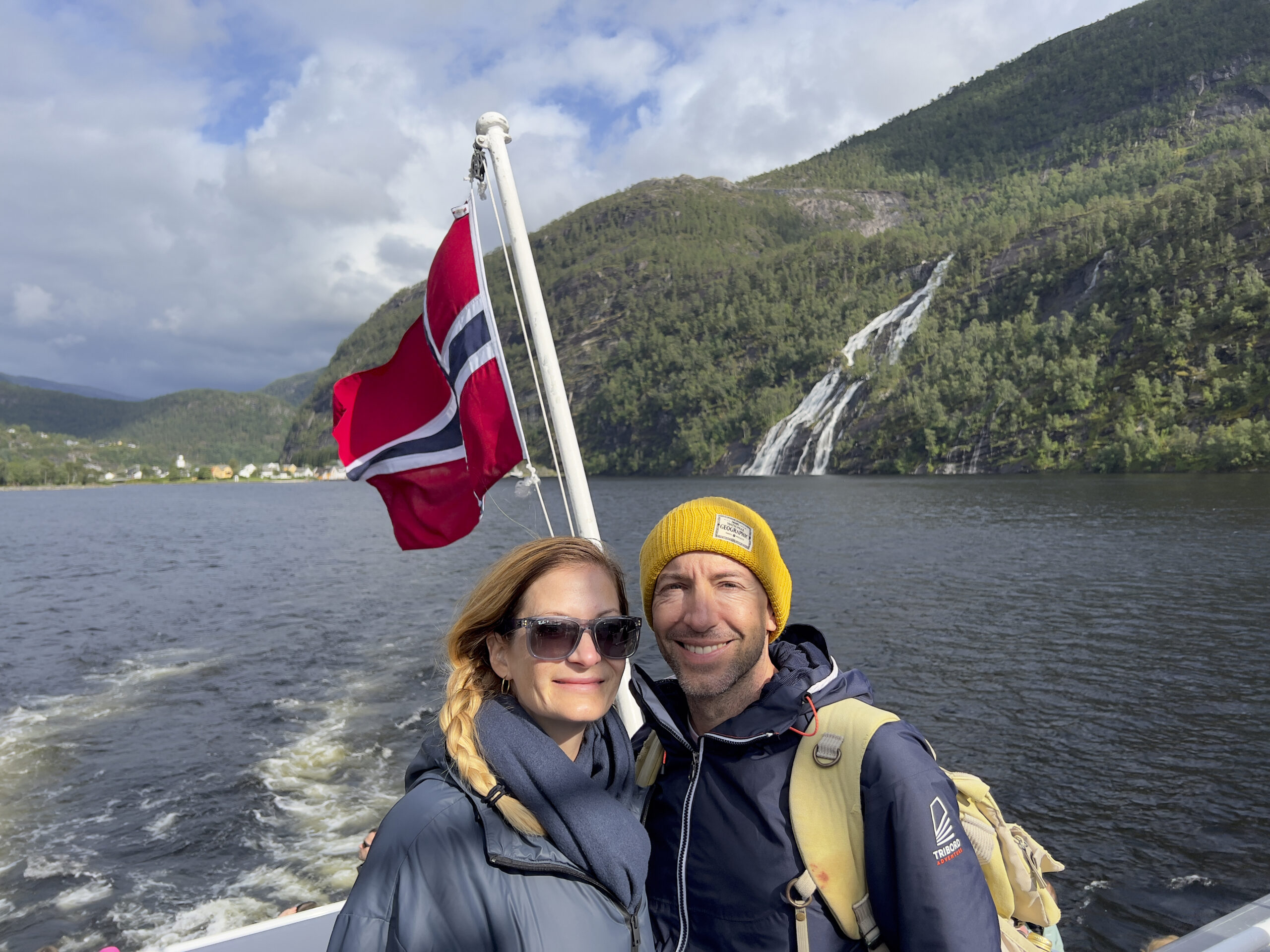 Couple on boat with flag.