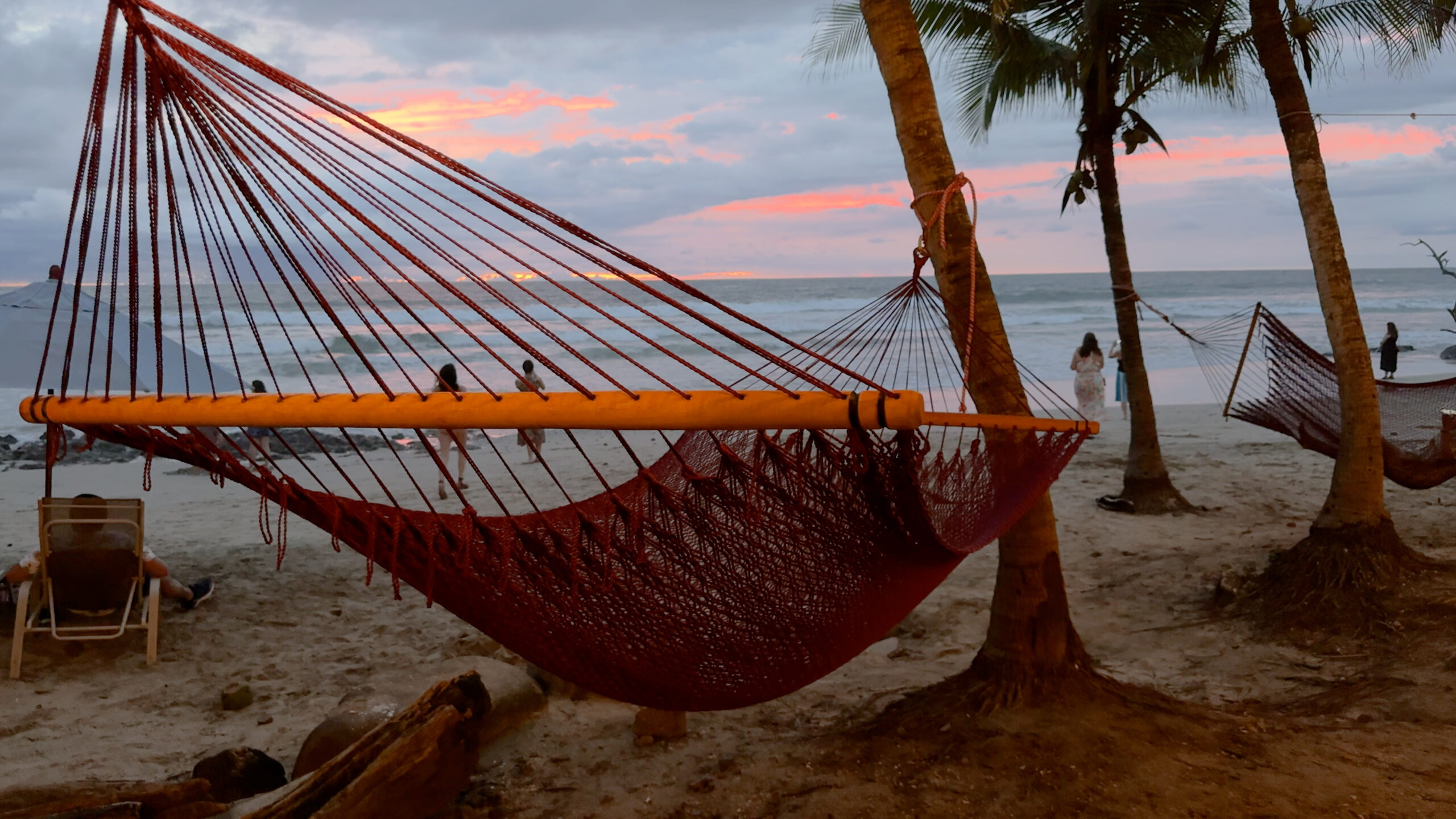 Hammock on beach at sunset.