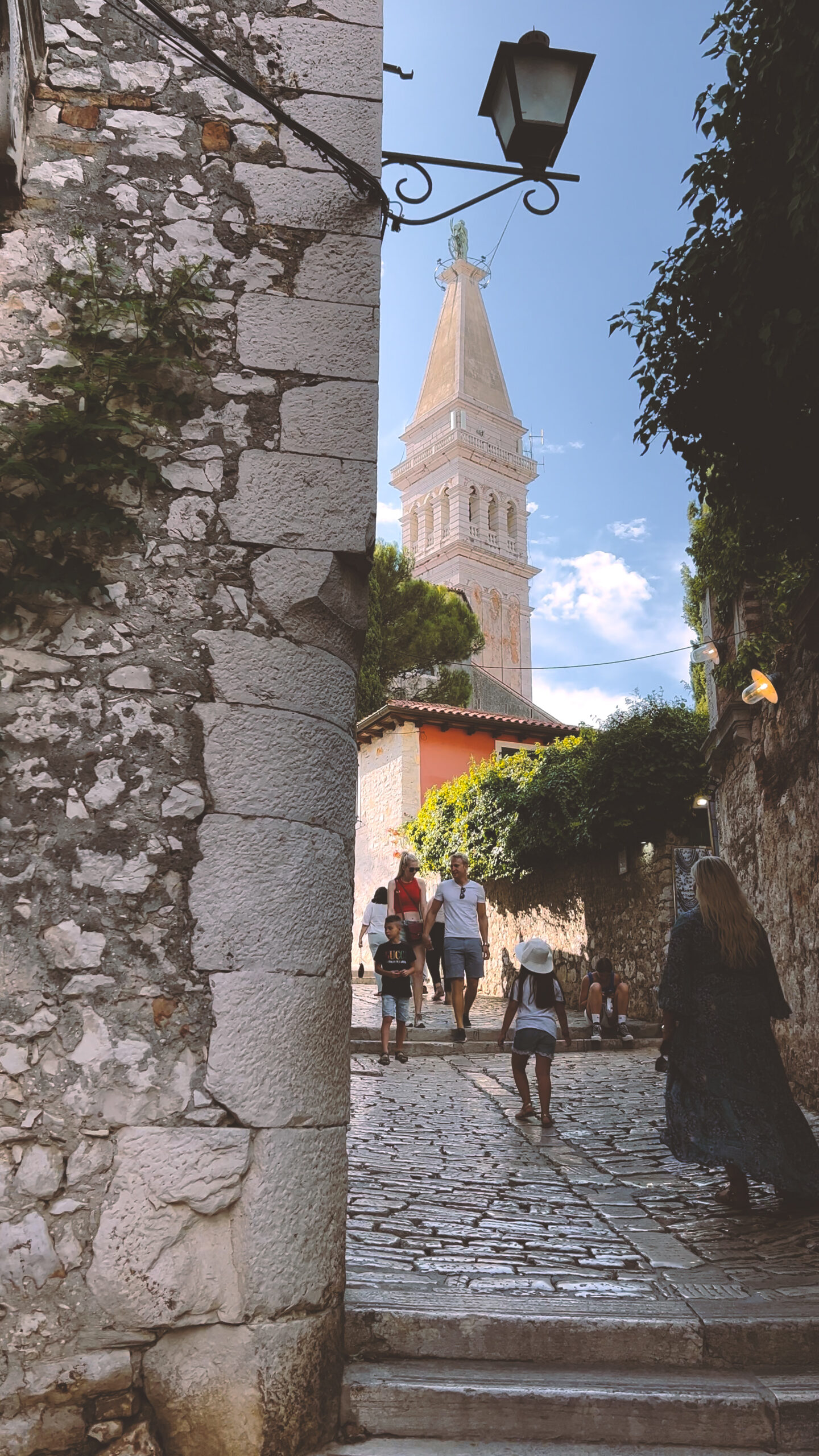 Archway to cobblestone street, tower