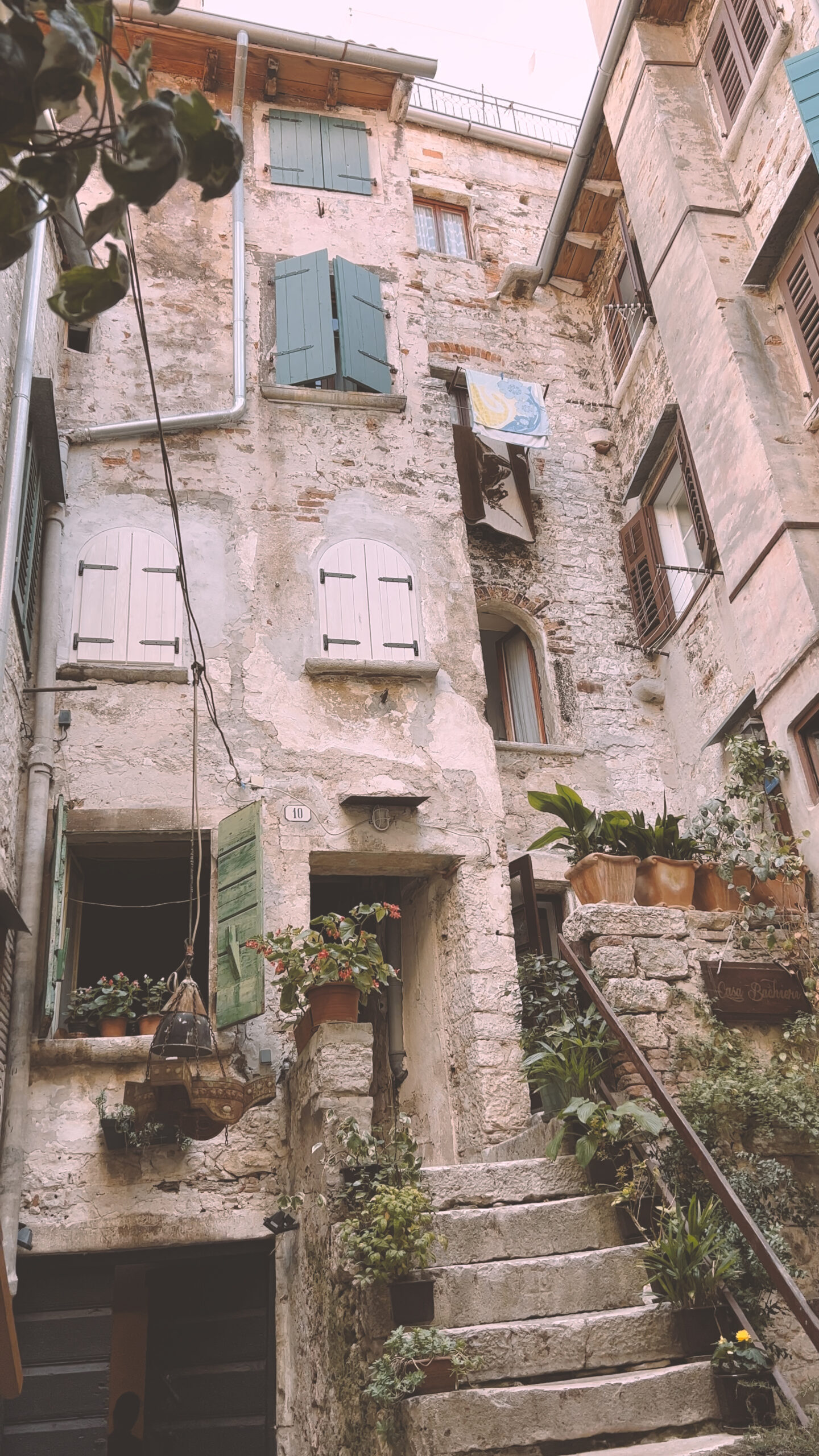 Rustic building with green shutters