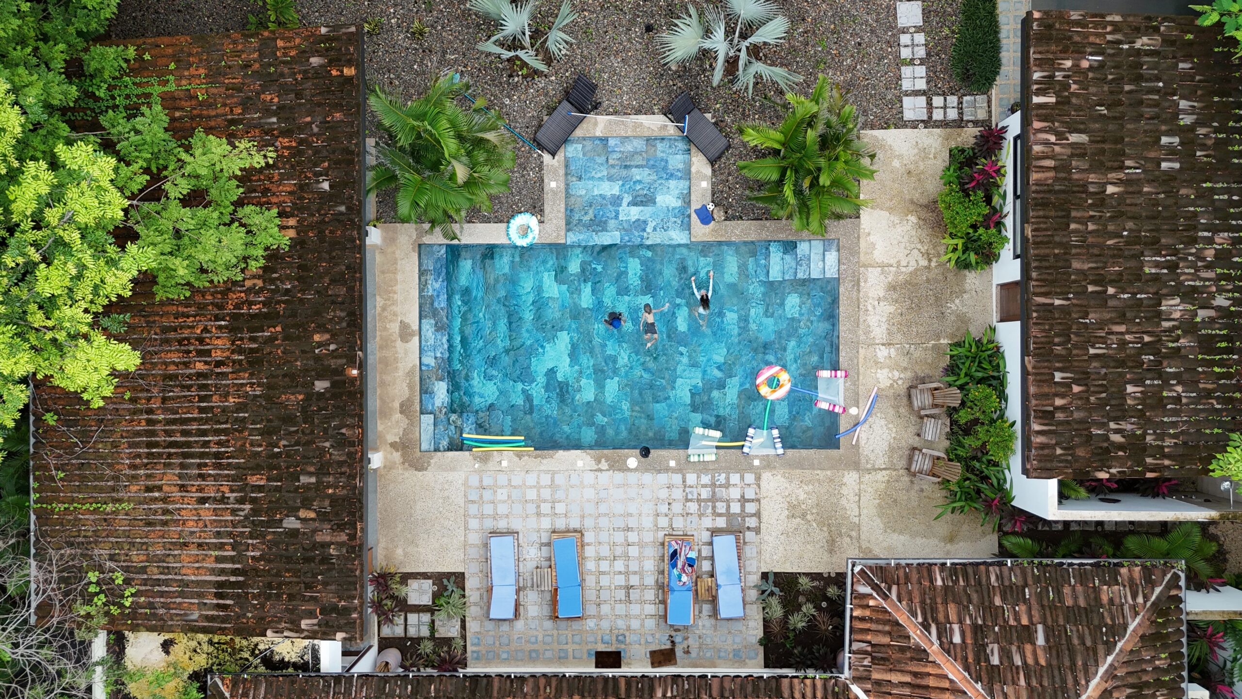 Aerial view of a pool with loungers.